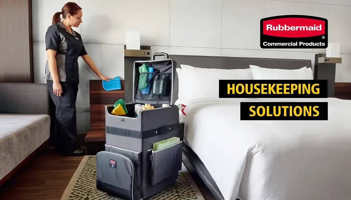 Cleaning staff with housekeeping cart and cleaning supplies in hotel room ready for housekeeping services.
