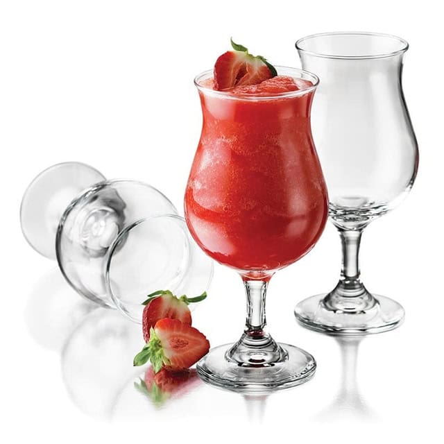 0020190_2.jpg Fresh strawberry smoothie in a tall glass with ice, strawberries, and clear glassware on a white background.