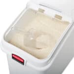 Fine white rice in a rice cooker with a transparent lid, ready for cooking or serving. Perfect for preparing fresh rice for Asian cuisine and food service establishments.