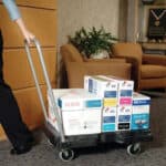 Xerox paper and toner boxes on a black utility cart in an office lounge area "Beyond Hygiene Asia".