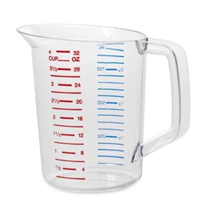 Measuring jug with red and blue measurement markings for liquids, transparent plastic, used in food preparation and cooking.