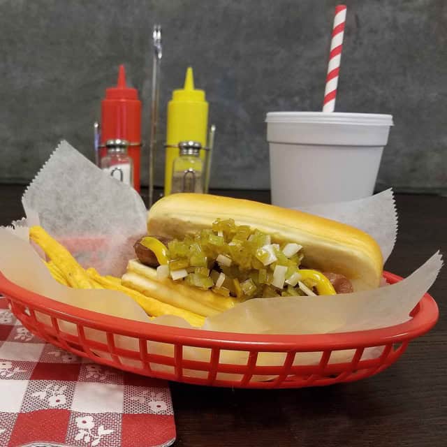 0048244_2.jpg Sodium hydroxide and citric acid bottles, fast food hotdog with relish in red basket, beverage cup with straw, condiment bottles, casual dining setting, Beyond Hygiene Asia.
