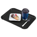 Freshly prepared ice cream cone with strawberries on a black tray, accompanied by a coffee cup and fork, showcasing food service hygiene and cleanliness.