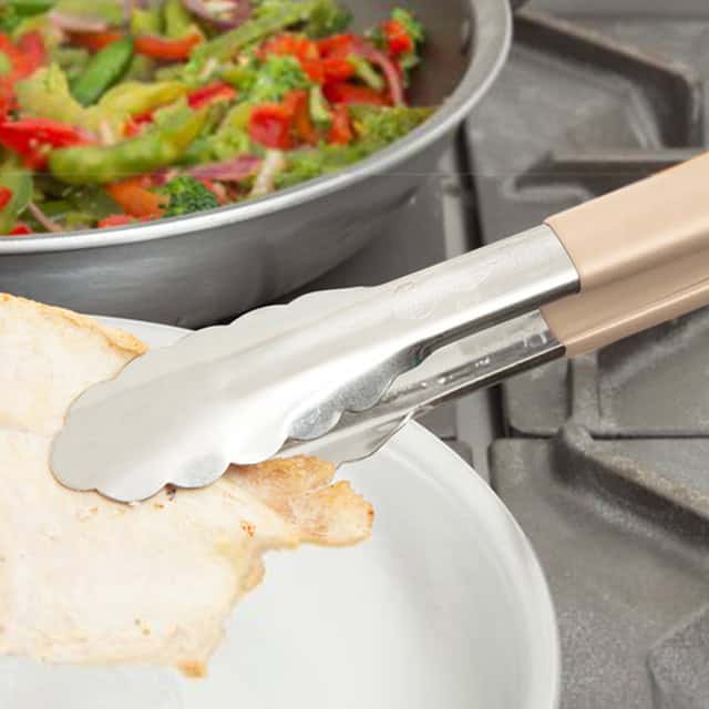 0055396_4.jpg Food tongs handling cooked chicken with fresh vegetable salad in the background at Beyond Hygiene Asia, emphasizing professional kitchen hygiene practices and food safety standards.