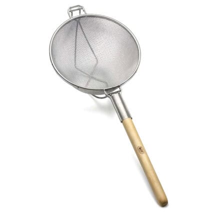 Stainless steel fine mesh skimmer with wooden handle, used in professional kitchen and food hygiene cleaning.