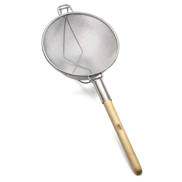 0056145_1.jpg Stainless steel fine mesh skimmer with wooden handle, used in professional kitchen and food hygiene cleaning.