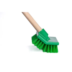 Green industrial push broom for commercial cleaning, ideal for industrial and warehouse floor sanitation.