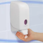 Dispenser for hand sanitizer or soap, mounted on a wall for hygiene and cleanliness.