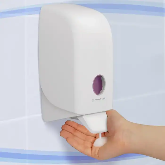 Dispenser for hand sanitizer or soap, mounted on a wall for hygiene and cleanliness.
