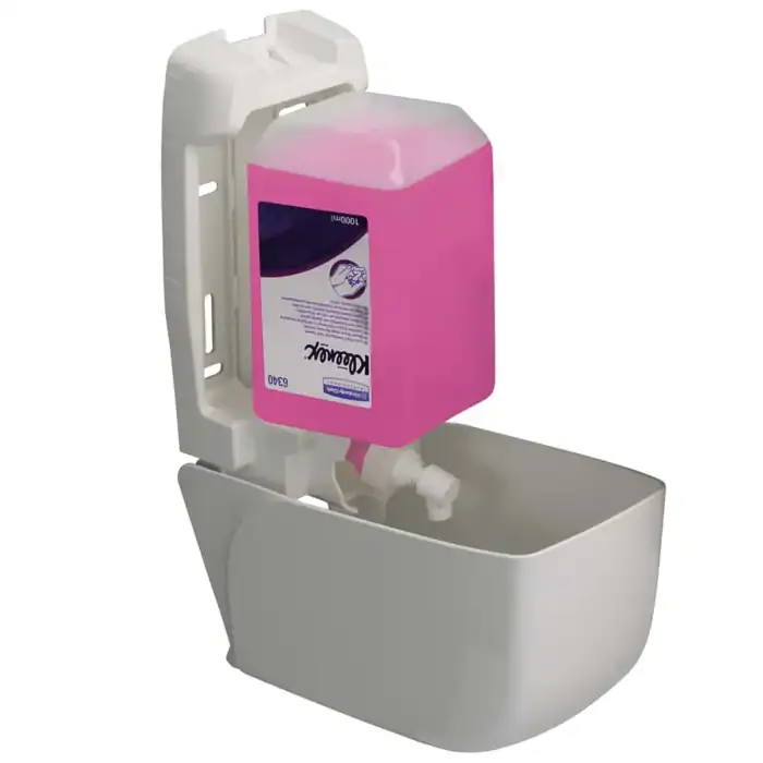 Refillable pink hand sanitizer dispenser attached to a wall in a hygiene station, ideal for commercial and healthcare settings to promote hand sanitation.