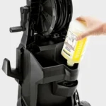 Disinfectant solution being poured into a commercial cleaning machine for enhanced hygiene and sanitation.