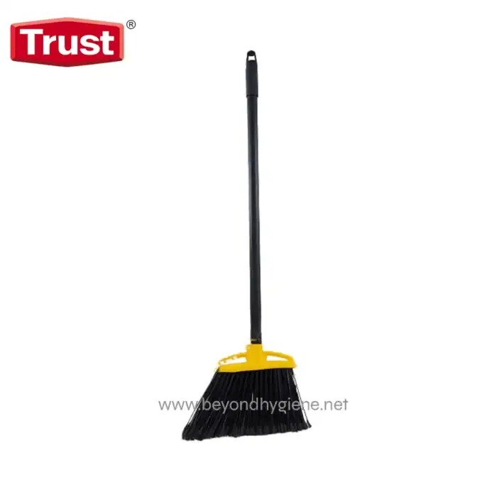 Broom with black bristles and yellow handle, used for cleaning floors, in front of a white background.