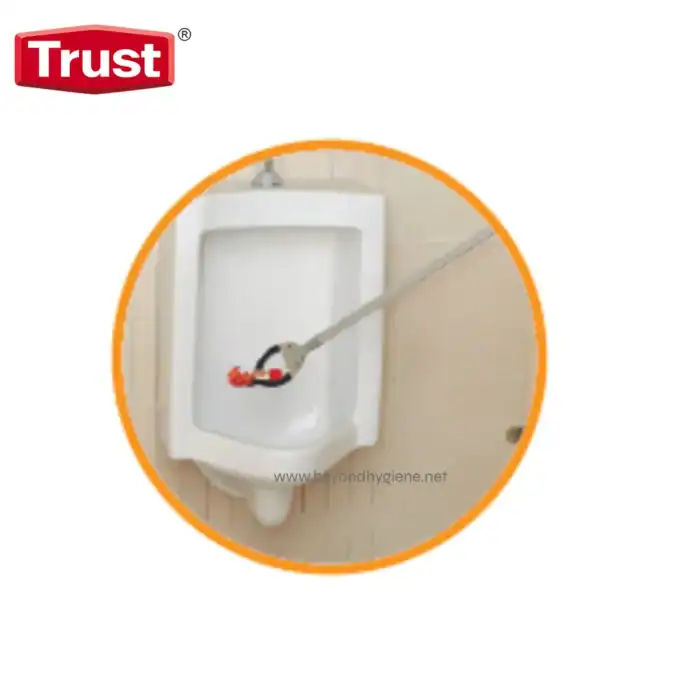 Disinfecting washroom urinal using high-pressure spray for hygiene and sanitation, part of Beyond Hygiene Asia's cleaning solutions.