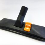 Vacuum cleaner floor attachment with hose and adjustable settings for cleaning carpets and hard floors.