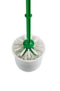 Disposable cleaning brush with green handle and white bristles in a white container, ideal for hygiene and sanitation purposes.