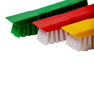 Green, red, and yellow cleaning scrub brushes with white bristles, antimicrobial cleaning tools for hygiene and sanitation in commercial and industrial settings, Beyond Hygiene Asia.