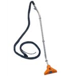 Heavy-duty commercial vacuum cleaner with long hose and wand for industrial cleaning tasks.