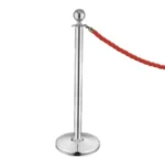 Stainless steel crowd control stanchion with red velvet rope for event barriers and queue management.