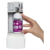 Dispensing a can of air freshener from a wall-mounted automatic dispenser, highlighting hygiene and air quality maintenance solutions.