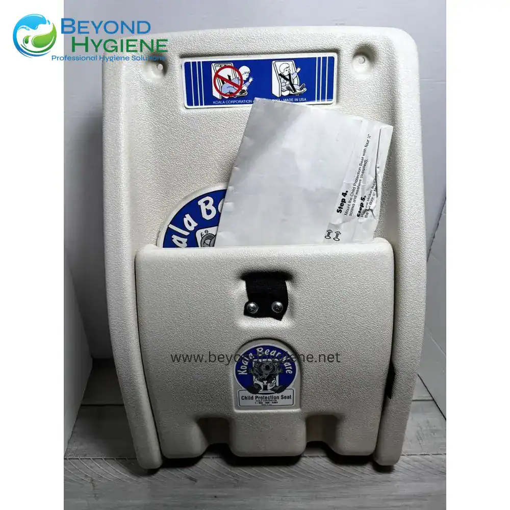 Koala Kare Child Protection Seat (1) Kiddie child protection seat in a public restroom for safe bathroom use by children, featuring a durable plastic design with safety stickers, providing hygiene and safety for young children.