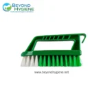 Green cleaning brush with handle for industrial hygiene cleaning tasks.