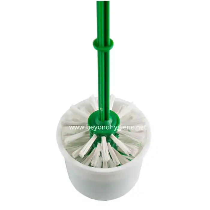 Disposable toilet brush cleaning tool with white bristles and green handle for hygiene maintenance in Asian bathrooms.