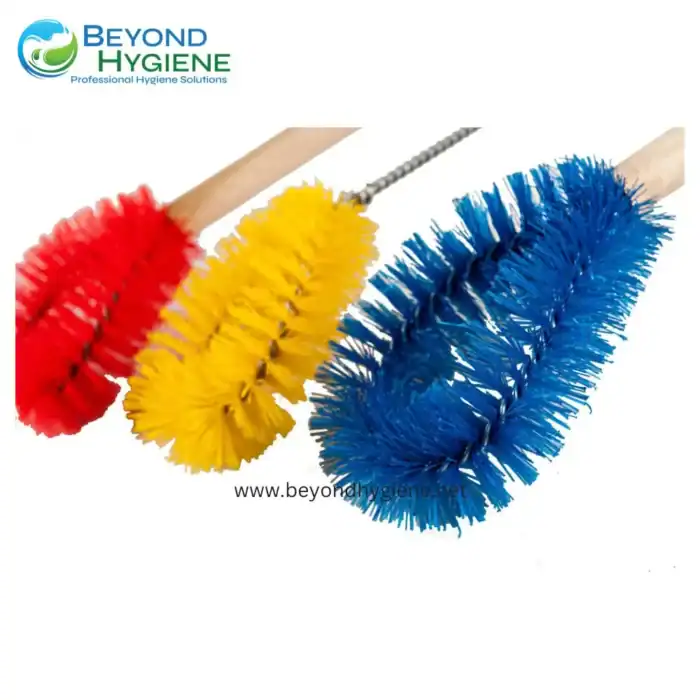 Red, yellow, and blue cleaning brushes with handle grips, used for sanitation and hygiene cleaning tasks in Asia, professional hygiene solutions, Beyond Hygiene Asia.
