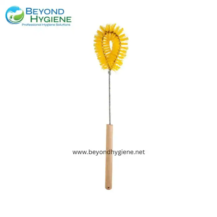 Cleaning brush with a yellow sponge head and wooden handle, used for professional hygiene cleaning solutions.