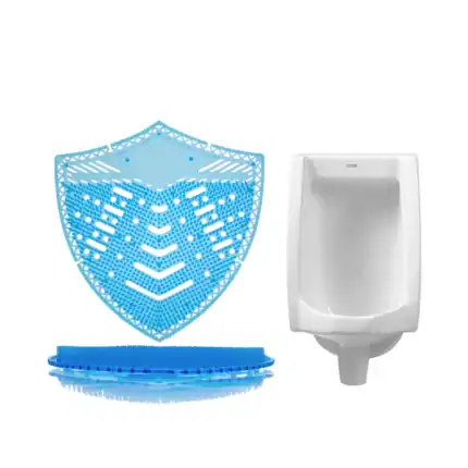 Blue plastic urinal deodorizer screen with a white urinal in the background, designed for hygiene and cleanliness in public restrooms. Perfect for maintaining fresh restroom air and preventing odors.