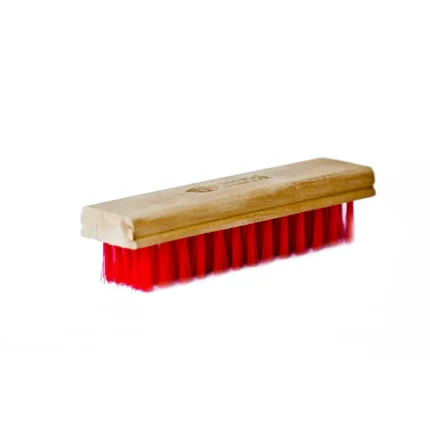 Bright red cleaning scrub brush with a wooden handle for hygiene and cleaning solutions for commercial and industrial spaces.