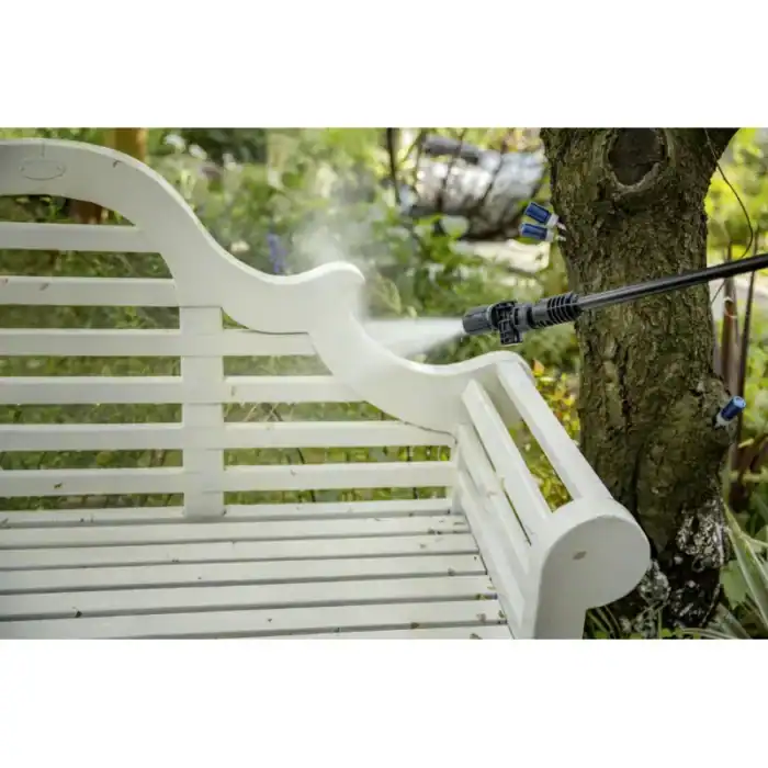 Spray disinfectant on white garden bench outdoors, cleaning greenery and tree trunk for hygiene, sanitation, outdoor sanitation services, Beyond Hygiene Asia, green environment cleaning services, outdoor disinfecting solutions.