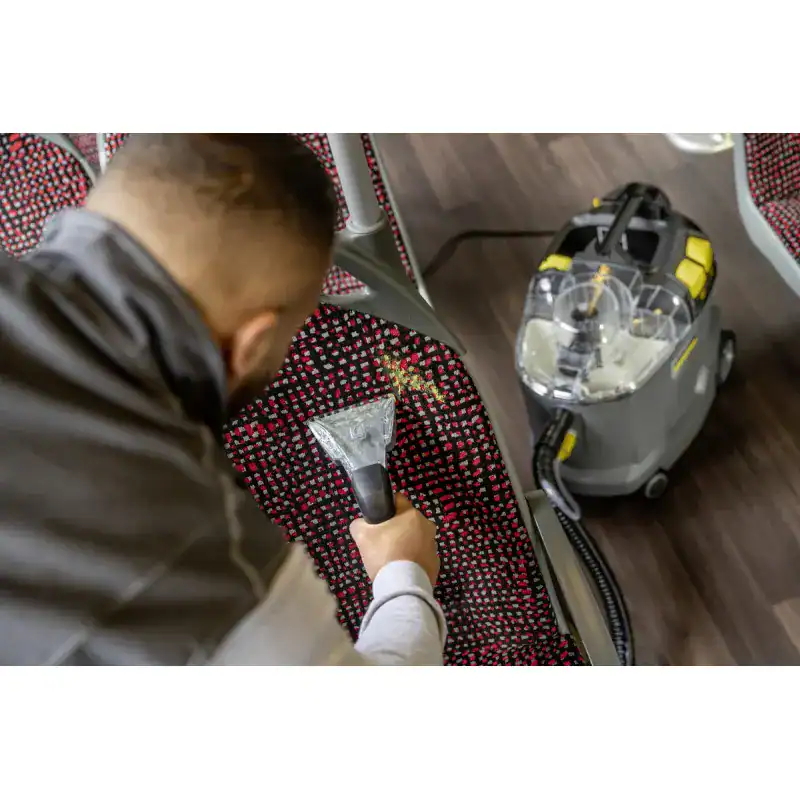 puzzi-8-1-eu (4) Disinfection technician using portable sanitizer to clean fabric seats at Beyond Hygiene Asia, specialized in professional cleaning and hygiene solutions for commercial and public spaces.
