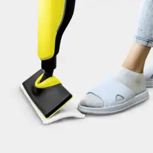 Efficient floor cleaning with a yellow and black vacuum cleaner on a white cloth, showcasing professional hygiene services.