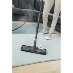 Deep cleaning carpet with dry vapor steam cleaner in a home setting, emphasizing professional sanitation and hygiene services by Beyond Hygiene Asia.