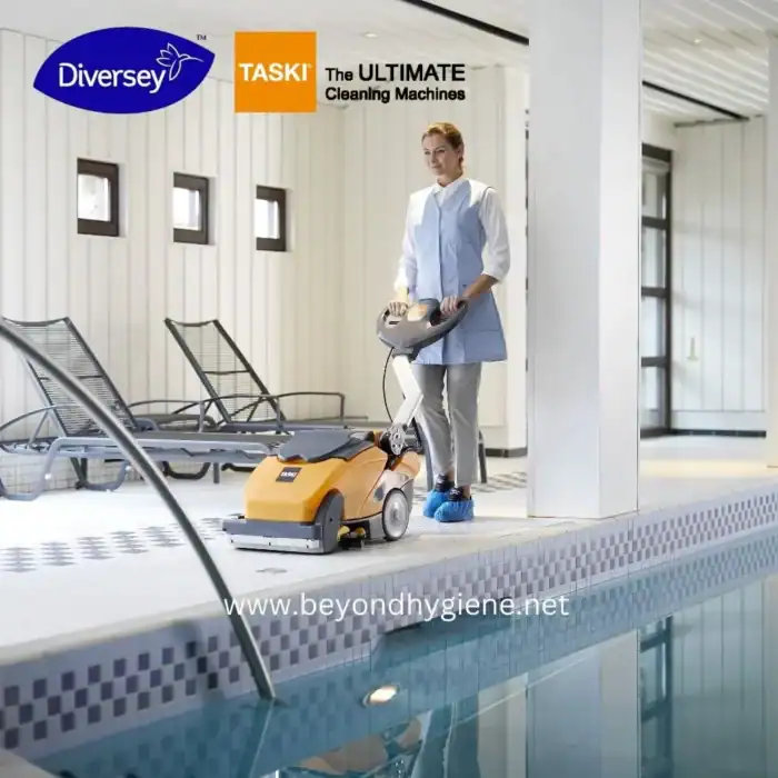 Industrial cleaning equipment in a modern indoor pool area, representing professional hygiene solutions for pool maintenance and sanitation.