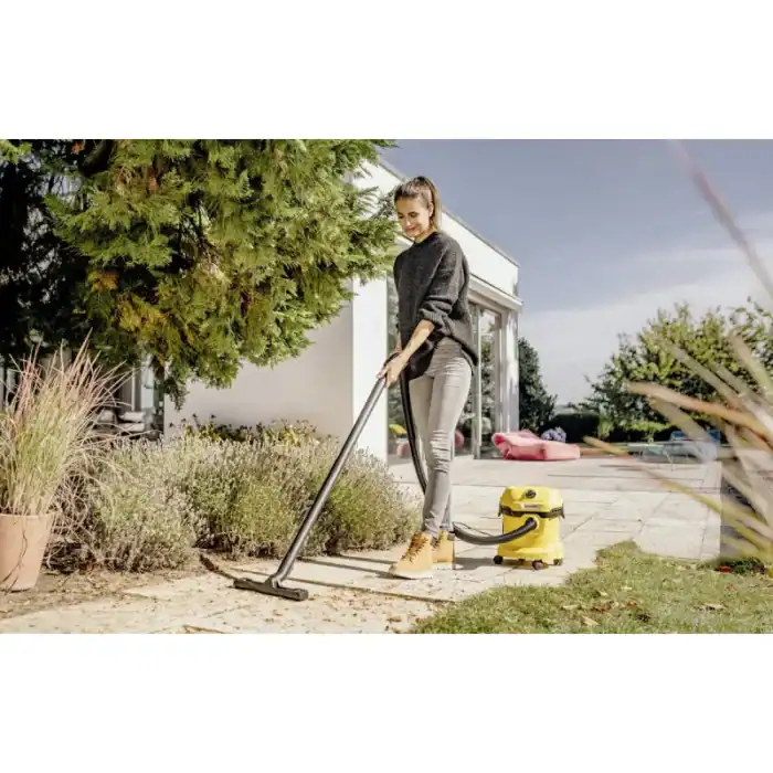 Vacuum cleaner outdoor garden cleaning, woman using yellow vacuum outside, eco-friendly cleaning, beyond hygiene asia, professional cleaning services.