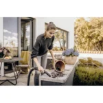 Flower garden maintenance, outdoor cleaning, woman using leaf blower to clean patio, outdoor terrace, gardening service, Beyond Hygiene Asia, professional outdoor cleaning services.