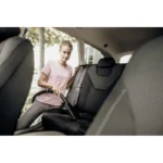 High-quality image of a woman vacuuming car interior, showcasing professional cleaning services by Beyond Hygiene Asia, specializing in vehicle sanitation and hygiene solutions.
