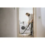 Vacuum cleaning in laundry room, professional cleaning service, beyond hygiene asia, hygienic laundry area, deep cleaning of household appliances.