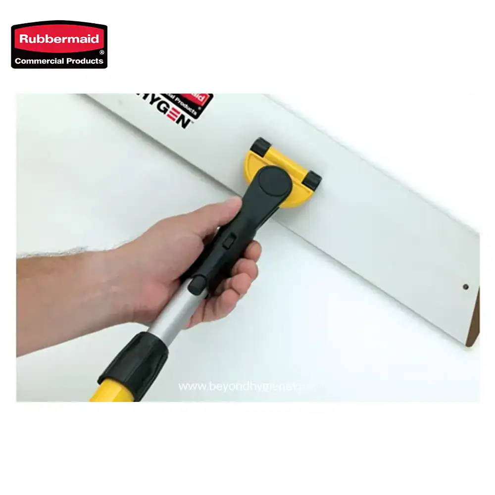 Image of a person using a yellow and black handheld tool to cut a white panel, with Beyond Hygiene branding in the background, emphasizing professional cleaning and hygiene equipment.
