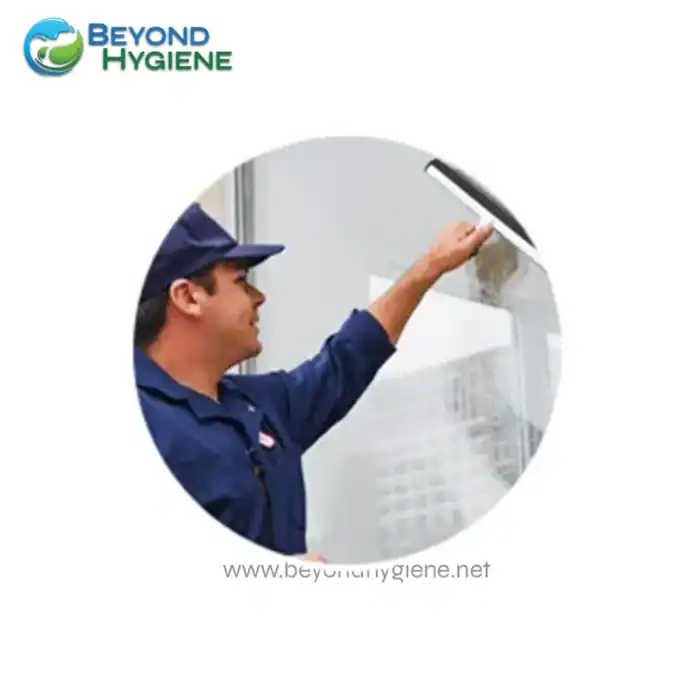 Deep cleaning staff disinfecting glass surface at Beyond Hygiene Asia in Singapore for commercial or industrial sanitation services.