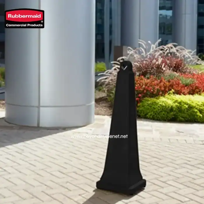 Rubbermaid commercial hand sanitizer stand outside modern building with landscaped garden.