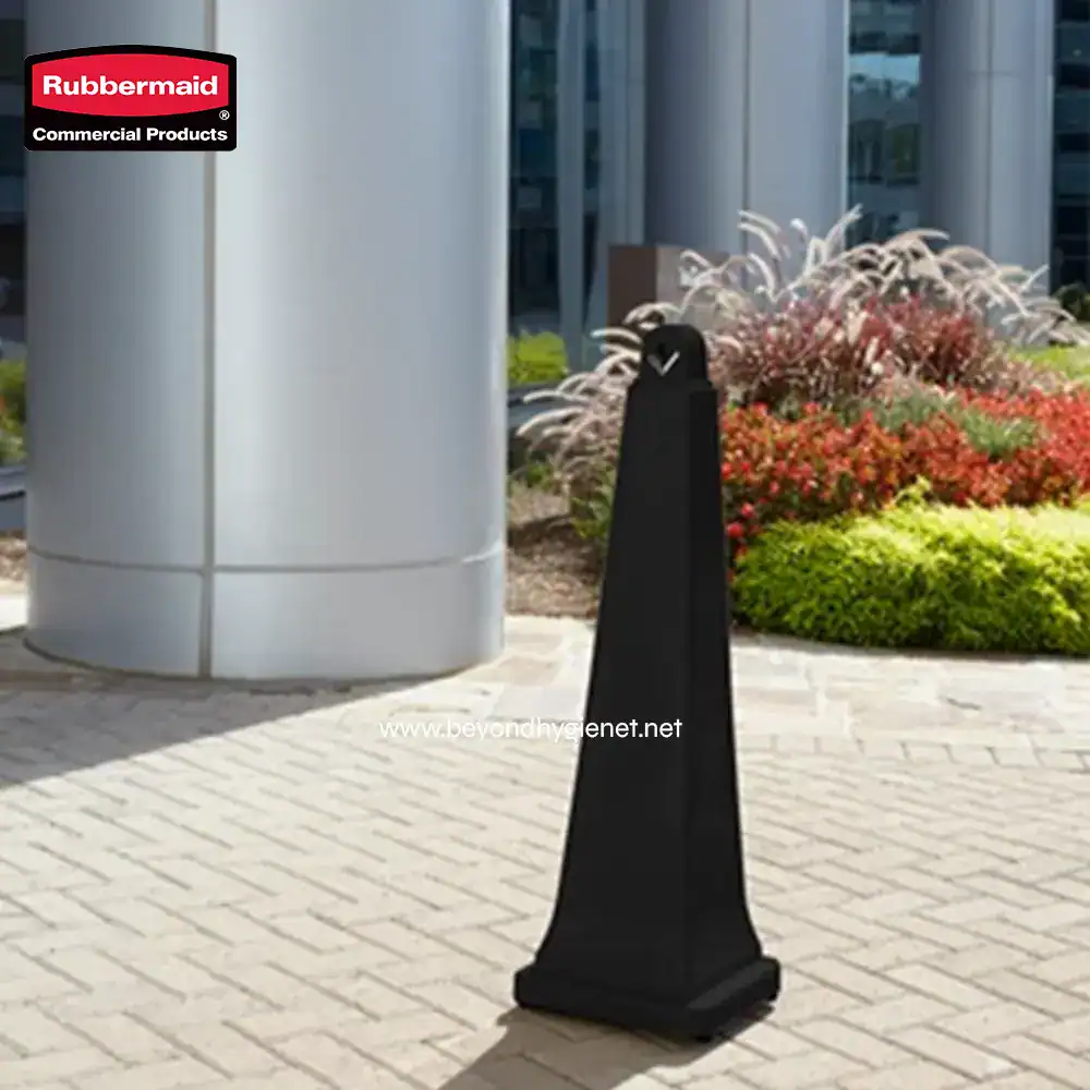 1007592 (1) Rubbermaid commercial hand sanitizer stand outside modern building with landscaped garden.