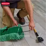 Microfiber cleaning mop being assembled on tiled floor for commercial cleaning.