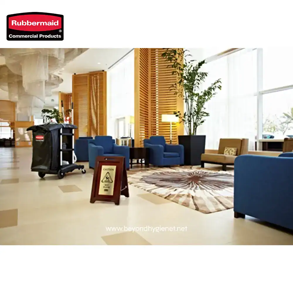 3 Disinfectant cleaning cart in modern hotel lobby with seating area and natural light, professional hygiene services by Beyond Hygiene Asia.