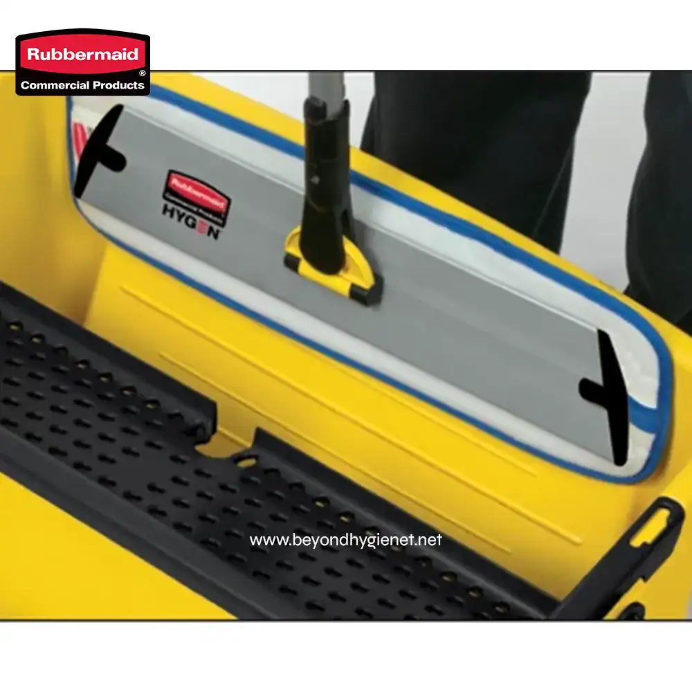 3 Rubbermaid Hygen cleaning tool with sturdy handle mounted on yellow cleaning cart, designed for commercial cleaning, janitorial, and hygiene maintenance purposes.