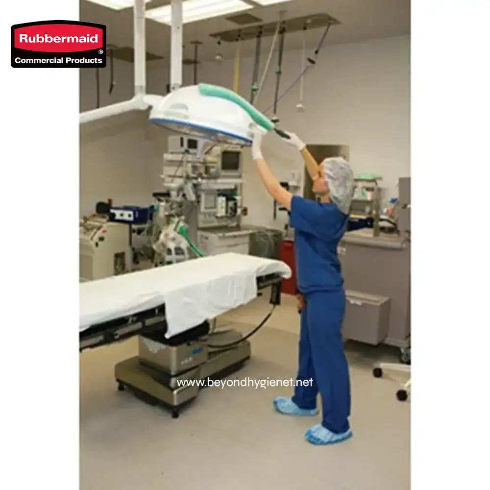 3 Disinfection process in hospital operating room with automated equipment and healthcare staff using protective gear.