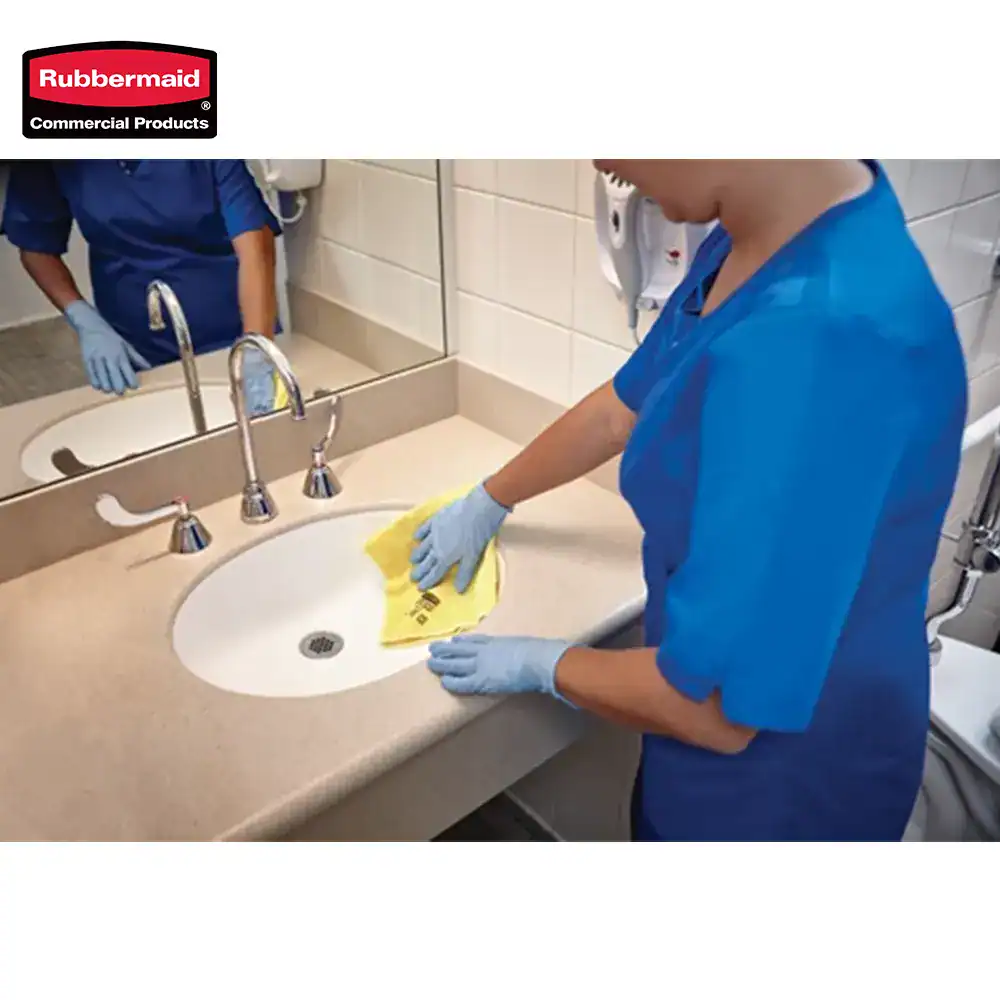 4 Disinfecting hospital sink with yellow cleaning cloth, healthcare workers ensuring hygiene, cleaning for infection control, bathroom cleaning service, sanitation practices in medical facilities.
