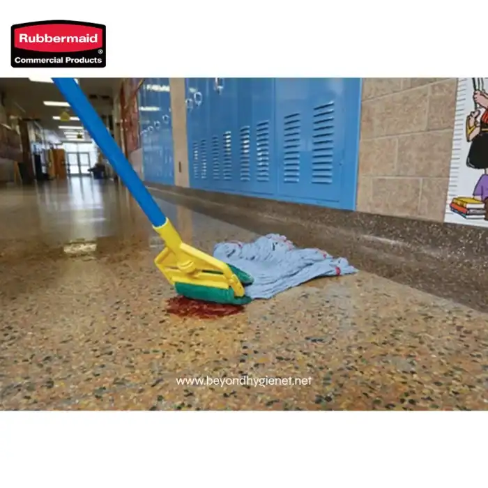Mop cleaning spill on school hallway floor, blue lockers in background, janitorial supplies, commercial cleaning, Beyond Hygiene Asia.