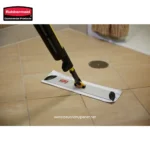 Rubbermaid cleaning product on tiled floor with drain in background, ideal for commercial cleaning and hygiene solutions.